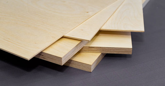 A stack of plywood boards layered on top of each other. The boards are of varying thicknesses from one another.